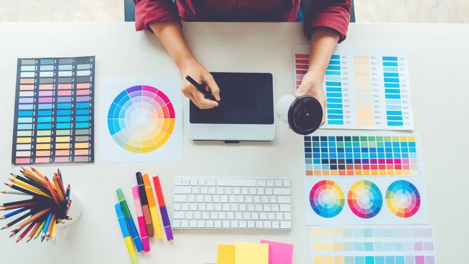 Overhead photograph showing a graphic designer at work.